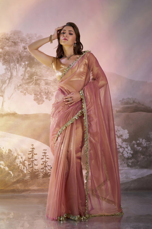 Light peach twill net saree with designer lace and unstitched blouse