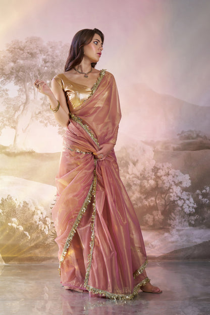 Light peach twill net saree with designer lace and unstitched blouse